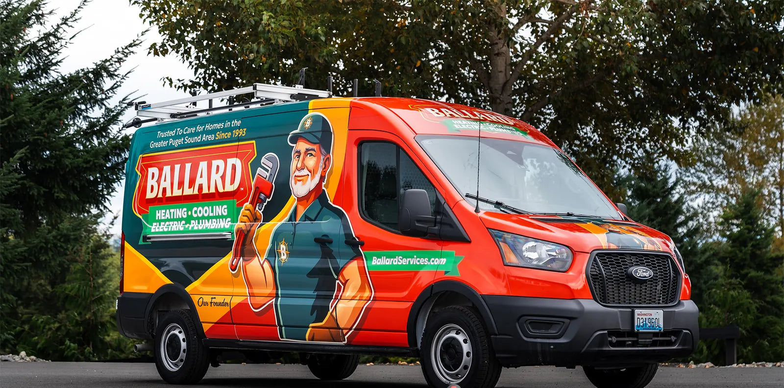 Ford Transit work van with a full orange, red and green wrap for a heating, cooling, electric and plumbing company, with a plumber mascot